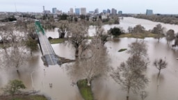 A view of flooding from the rainstorm-swollen Sacramento and American Rivers, near downtown Sacramento, California, Jan. 11, 2023. 