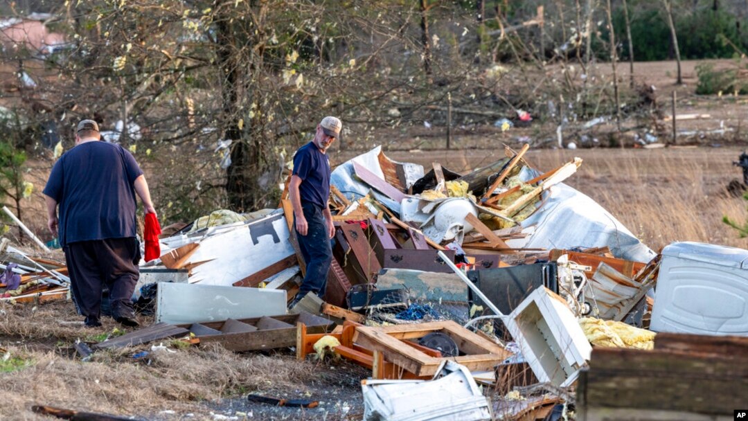 Scott Wayman, centro, examina su antigua casa de alquiler en 1349 County Road 43 después del mal tiempo, el 12 de enero de 2023, en Prattville, Alabama, EEUU.