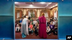 Actors perform to children at the Dzherelo rehabilitation center during celebrations for Saint Nicholas Day, in Kyiv, Ukraine, Monday, Dec. 19, 2022. (AP Photo/Evgeniy Maloletka)