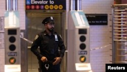 FILE - A New York Police Department officer patrols inside a subway station in the Manhattan borough of New York City, Oct. 29, 2022.