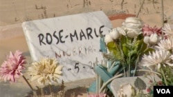 The gravestone of a Nigerian migrant worker who died at sea in 2017 is seen at the Cemetery of the Unknowns in Zarzis, Tunisia. (Lisa Bryant/VOA)