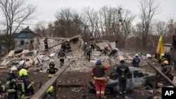 Emergency workers remove debris of a house destroyed following a Russian missile strike in Kyiv, Ukraine, Dec. 29, 2022. 