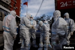 Pandemic prevention workers in protective suits prepare to enter an apartment compound that was placed under lockdown as outbreaks of the coronavirus disease (COVID-19) continue in Beijing, China, November 12, 2022.