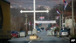 Serb protesters stand at the barricade near the village of Rudare, close to Zvecan, near the northern, Serb-dominated part of ethnically divided town of Mitrovica, Kosovo, Dec. 29, 2022.