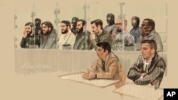 In this courtroom sketch, seven defendants sit behind a specially designed glass box, while two sit on the outside during the trial for the Brussels attacks that took place on March 22, 2016, at the Justitia building in Brussels, Dec. 5, 2022. 