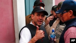 FILE - Opposition leader Luis Fernando Camacho gives a thumbs-up outside the presidential palace in La Paz, Bolivia, after President Evo Morales announced his resignation to the presidency Nov. 10, 2019. 