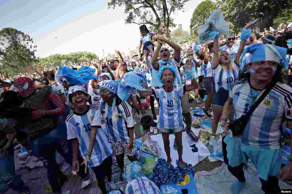 Argentina fans in Buenos Aires celebrate after Argentina&#39;s Lionel Messi scores the first goal in a World Cup semifinal match against Argentina in Qatar, Dec. 13, 2022.