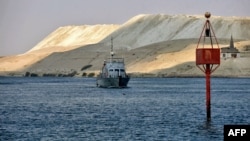 FILE - An Egyptian navy craft patrols the Suez Canal on March 30, 2021. 