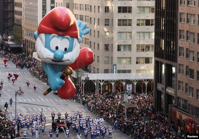 FILE - Papa Smurf flies over the crowd during the 96th Macy's Thanksgiving Day Parade in New York City, Nov. 24, 2022. (REUTERS/Brendan McDermid)