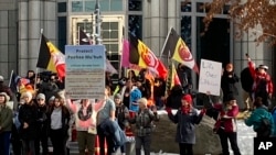 Tribe members and other protesters rally in front of the federal courthouse in Reno, Nevada, Jan. 5, 2023, as a court hearing began over a lawsuit seeking to block a lithium mine planned about 200 miles north of Reno. 