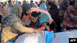 Family members mourn next to the bodies of residents killed in the remote village of Dangri in Rajouri district, Jan. 2, 2023.