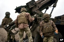 Ukrainian soldiers prepare to fire a French-made CAESAR self-propelled howitzer towards Russian positions near Avdiivka, Donetsk region, Ukraine, Dec. 26, 2022.