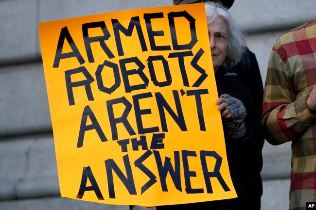 Diana Scott holds up a sign while taking part in a demonstration about the use of robots by the San Francisco Police Department outside of City Hall in San Francisco, Monday, Dec. 5, 2022. (AP Photo/Jeff Chiu, File)