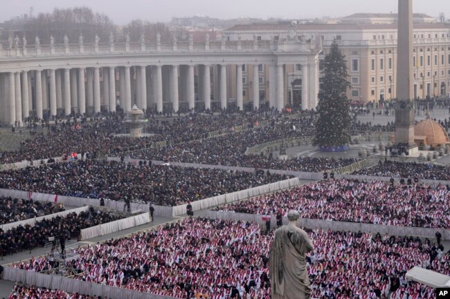 Faithful attend the funeral mass for late Pope Emeritus Benedict XVI in St. Peter's Square at the Vatican, Jan. 5, 2023. (AP Photo/Ben Curtis)