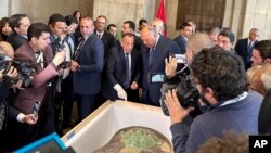 Egyptian Foreign Minister Sameh Shoukry, center right, and Mostafa Waziri, top official at the Supreme Council of Antiquities, talk in front of an ancient wooden sarcophagus during a handover ceremony at the Foreign Ministry in Cairo, Egypt, Jan. 2, 2023.