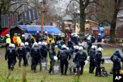 Police officers gather at the village Luetzerath near Erkelenz, Germany, Jan. 12, 2023.