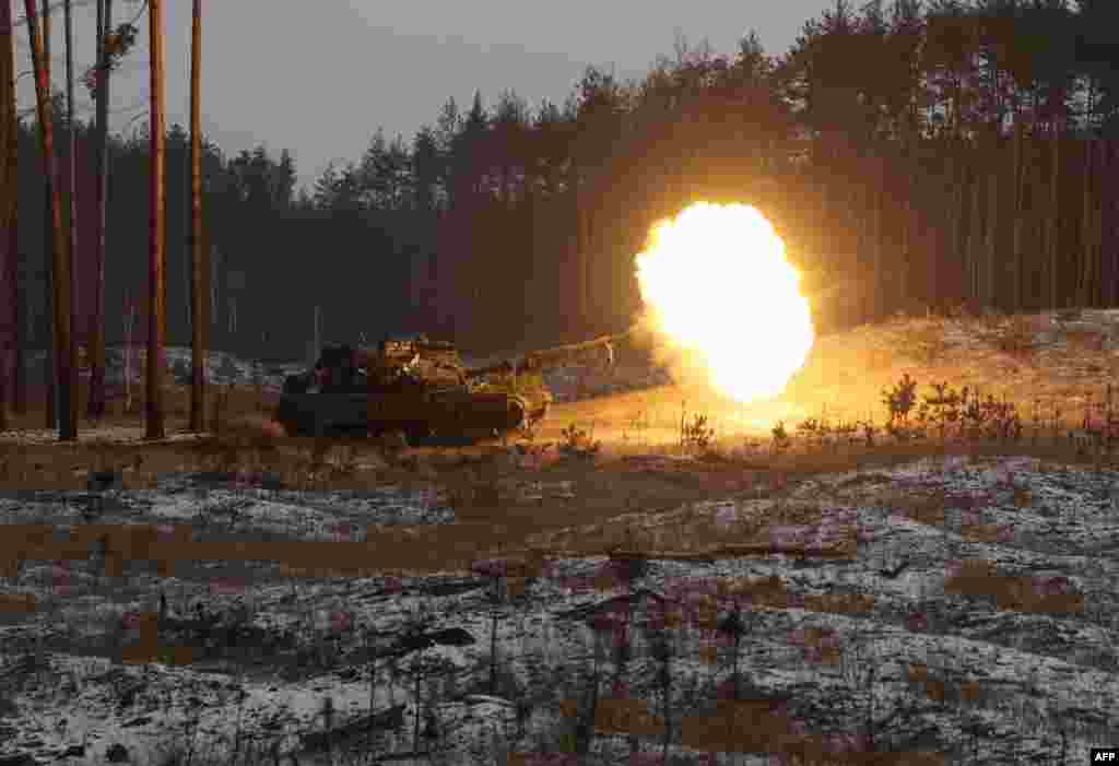 A Ukrainian tank fires at Russian positions near Kreminna, Lugansk region, amid the Russian invasion of Ukraine.