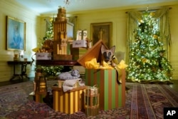 Depictions of Willow, bottom left, and Commander, the Biden family's cat and dog, are part of decorations in the Vermeil Room of the White House during a press preview of holiday decorations at the White House, Nov. 28, 2022, in Washington.