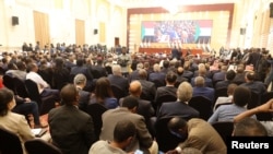 Attendees sit at the ceremony to sign the framework agreement between military rulers and civilian power in Khartoum, Sudan, Dec. 5, 2022. 