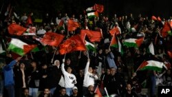 Palestinians in the West Bank town of Nablus watch a broadcast of the World Cup match between Morocco and Portugal, Dec. 10, 2022. 