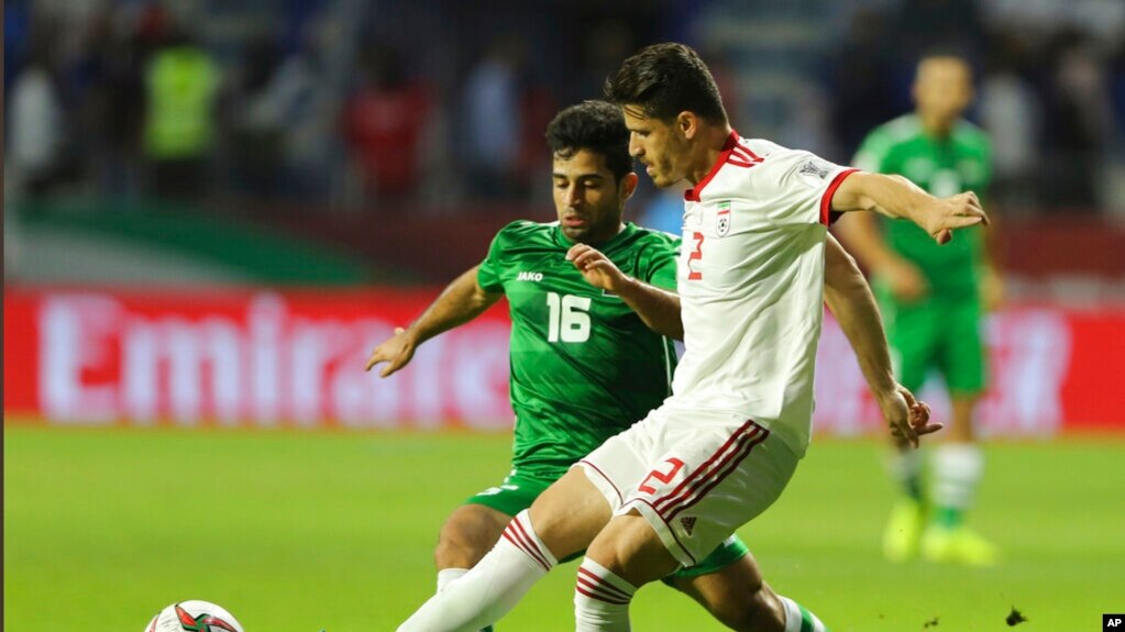 FILE— Voria Ghafouri, right, then an Iranian national soccer team player, fights for the ball during the AFC Asian Cup soccer match at the Al Maktoum Stadium in Dubai, United Arab Emirates, Jan. 16, 2019. 