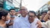 Mya Aye, center-left, a prominent political activist who was imprisoned in February of 2021, is greeted as he walks free after his release from Insein prison in Yangon, Myanmar Nov. 17, 2022. (Assistance Association for for Myanmar Based Independent Journalists via Reuters.)