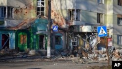 A local resident walks along a street in the area of the heaviest battles with the Russian invaders in Bakhmut, Ukraine, Dec. 20, 2022.