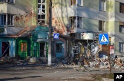 A local resident walks along a street in the area of the heaviest battles with the Russian invaders in Bakhmut, Ukraine, Dec. 20, 2022.