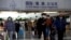 Travelers walk with their luggage at Beijing Capital International Airport, amid the COVID-19 outbreak in Beijing, Dec. 27, 2022. 