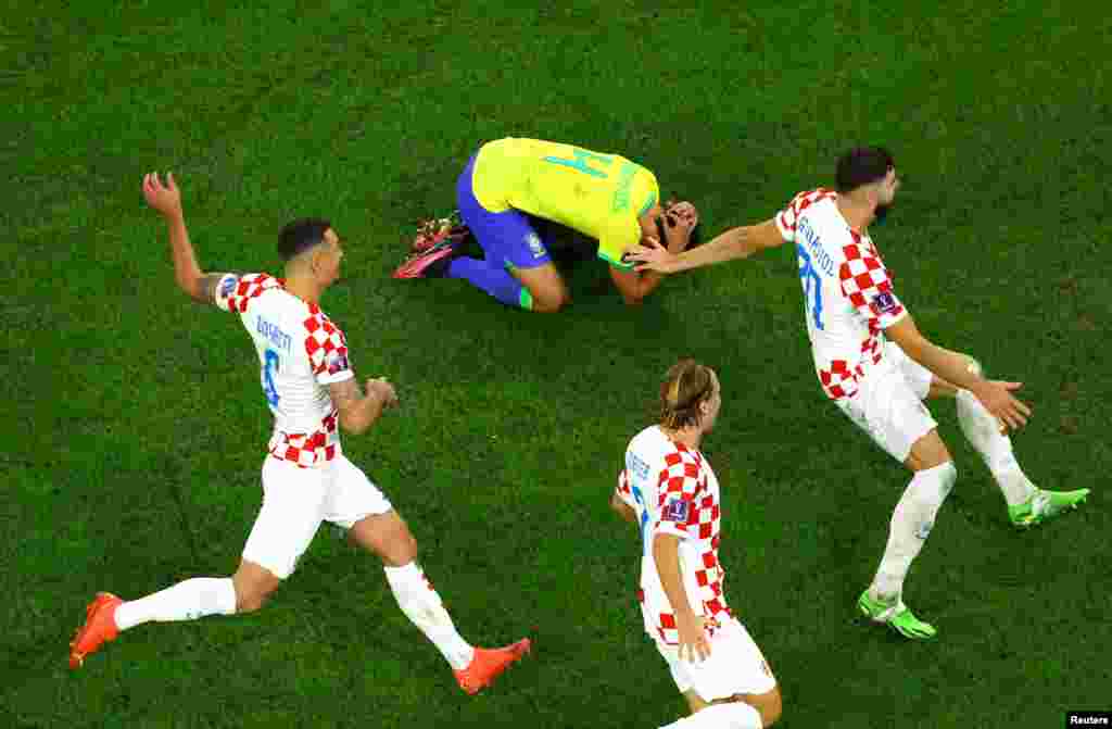 Croatian players celebrate after winning the penalty shootout and qualifying for the semi final, Dec. 9, 2022, at Education City Stadium, Doha, Qatar.