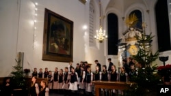 Shchedryk youth choir members leave the stage, following a Christmas concert at Copenhagen’s Church of the Holy Spirit, in Copenhagen, Denmark, Thursday, Dec. 8 2022.