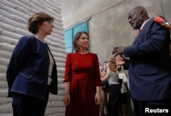 World Food Program Country Director for Ethiopia, Claude Jibidar, talks to German Foreign Minister Annalena Baerbock and her French counterpart Catherine Colonna during their visit to the WFP warehouse in Adama, Ethiopia, Jan. 12, 2023.