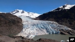 FILE - Chunks of ice float in front of the Mendenhall Glacier on Monday, May 30, 2022, in Juneau, Alaska. A study of all of the world's 215,000 glaciers published Jan. 5, 2023, finds with only a few tenths of a degrees more, the world will lose nearly half its glaciers by 2099.