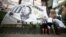 Fans install a flag with the image of Brazilian soccer legend Pele during a vigil outside the Albert Einstein Israelite Hospital entrance, where he is hospitalized, in Sao Paulo, Brazil, Dec. 4, 2022.