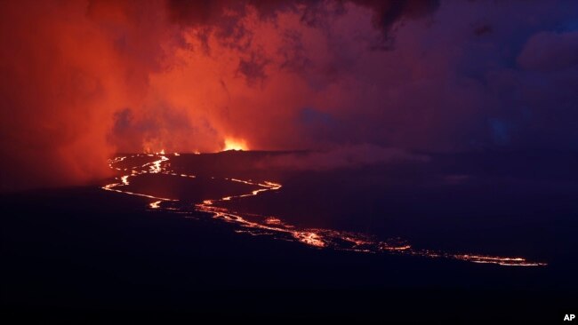 Lava flows down the mountain from the Mauna Loa eruption, Nov. 29, 2022, near Hilo, Hawaii.