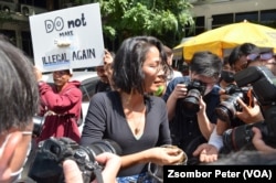 Chokwan Chopaka of the People's Network for Cannabis Legislation in Thailand hands out free samples at a rally in Bangkok, Nov. 22, 2022.