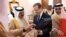 In this handout picture obtained from the Israeli Government Press Office (GPO), Bahrain's King Hamad bin Isa al-Khalifa receives a gift from Israeli President Herzog in the capital Manama, Dec. 4, 2022.