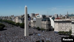 People flock to the Obelisco ahead of the victory parade for the players of the Argentine soccer team, in Buenos Aires, Dec. 20, 2022.