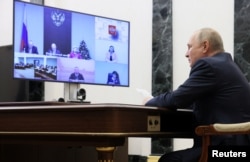 Russian President Vladimir Putin holds the annual meeting of the Presidential Council for Civil Society and Human Rights, via video link in Moscow, Dec. 7, 2022. (Sputnik/Mikhail Metzel/Pool via Reuters)