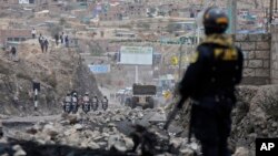 Police arrive in Arequipa, Peru, to clear a highway of debris placed by supporters of ousted Peruvian President Pedro Castillo, Dec. 15, 2022. 