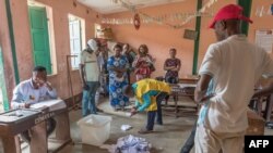 FILE: Members of the observers and the CENA (Commission Electorale Nationale Autonome) check the number of votes following the legislative elections at the public primary school, Charles Guillot de Zongo in Cotonou on January 8, 2023.