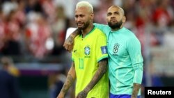 Brazil's Neymar, left, and Dani Alves are dejected after losing the penalty shootout to Croatia in the World Cup on Dec. 9, 2022.