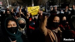 Afghan women chant slogans in protest against the closure of universities to women by the Taliban in Kabul, Dec. 22, 2022.