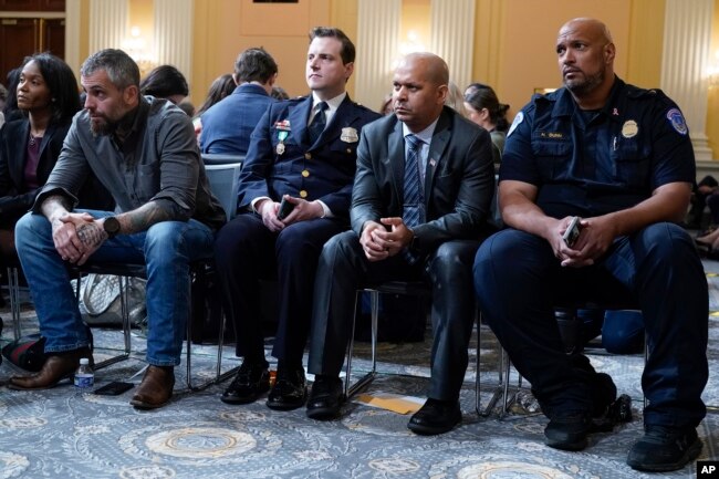 FILE - From left, Serena Liebengood, widow of U.S. Capitol Police officer Howie Liebengood, former Washington Metropolitan Police Department officer Michael Fanone Washington Metropolitan Police Department officer Daniel Hodges, U.S. Capitol Police Sgt. Aquilino Gonell and U.S. Capitol Police Sgt. Harry Dunn listen as the House select committee investigating the Jan. 6 attack on the U.S. Capitol holds a hearing on Capitol Hill in Washington, Oct. 13, 2022.