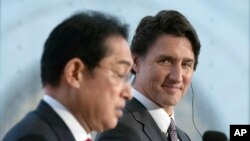 Canadian Prime Minister Justin Trudeau smiles as he listens to Japanese Prime Minister Fumio Kishida speak during a joint news conference, Jan. 12, 2023 in Ottawa.
