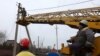 Workers repair broken power lines in Tatianovka village near Svyatohirs'k in Donetsk region on Nov. 25, amid the Russian invasion of Ukraine. 