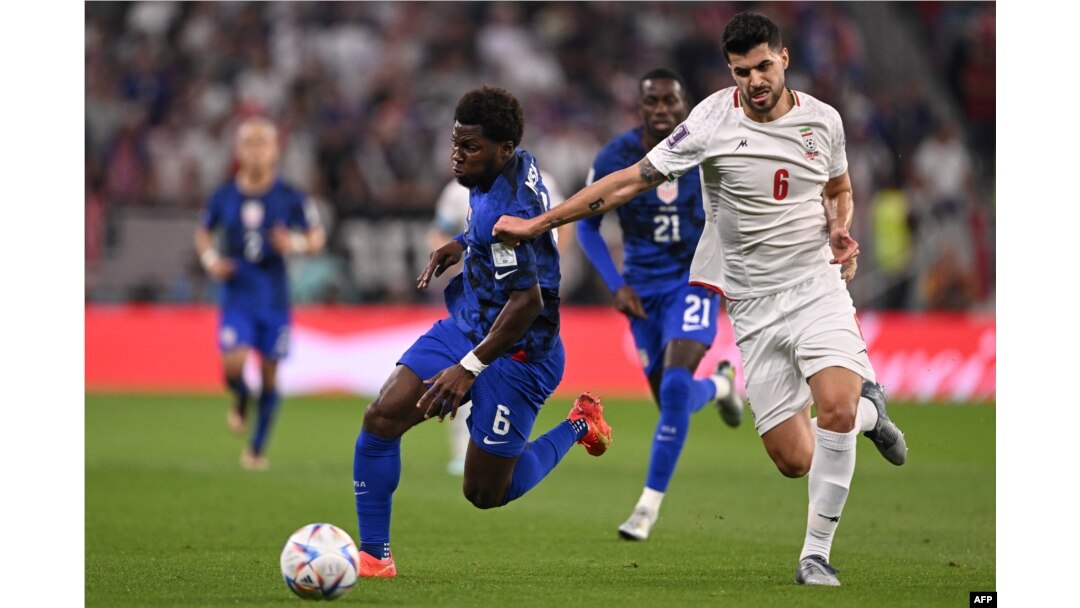 FILE - Iran's midfielder Saeid Ezatolahi, right, fights for the ball with USA's midfielder Yunus Musah during the Qatar 2022 World Cup Group B football match between Iran and USA at the Al-Thumama Stadium in Doha, Nov. 29, 2022.
