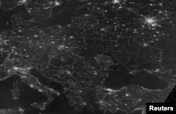 A grey-scale satellite image indicating the night radiance of Europe from space, Nov. 23, 2022, in this handout image obtained by Reuters on Nov. 24, 2022. Ukraine, at the right side of the photo, has less light activity, caused by Russia's attack on Ukraine's infrastructure.