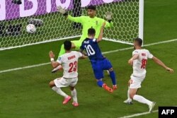 USA's Christian Pulisic scores his team's first goal past Iran's goalkeeper Alireza Beiranvand during the Qatar 2022 World Cup Group B football match on November 29, 2022.