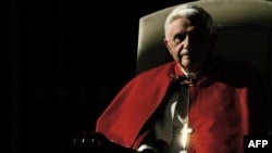 FILE: In this photo taken on December 7, 2005 the cross of Pope Benedict XVI reflects the sun as he attends his traditional weekly general audience in St Peter's square at Vatican.